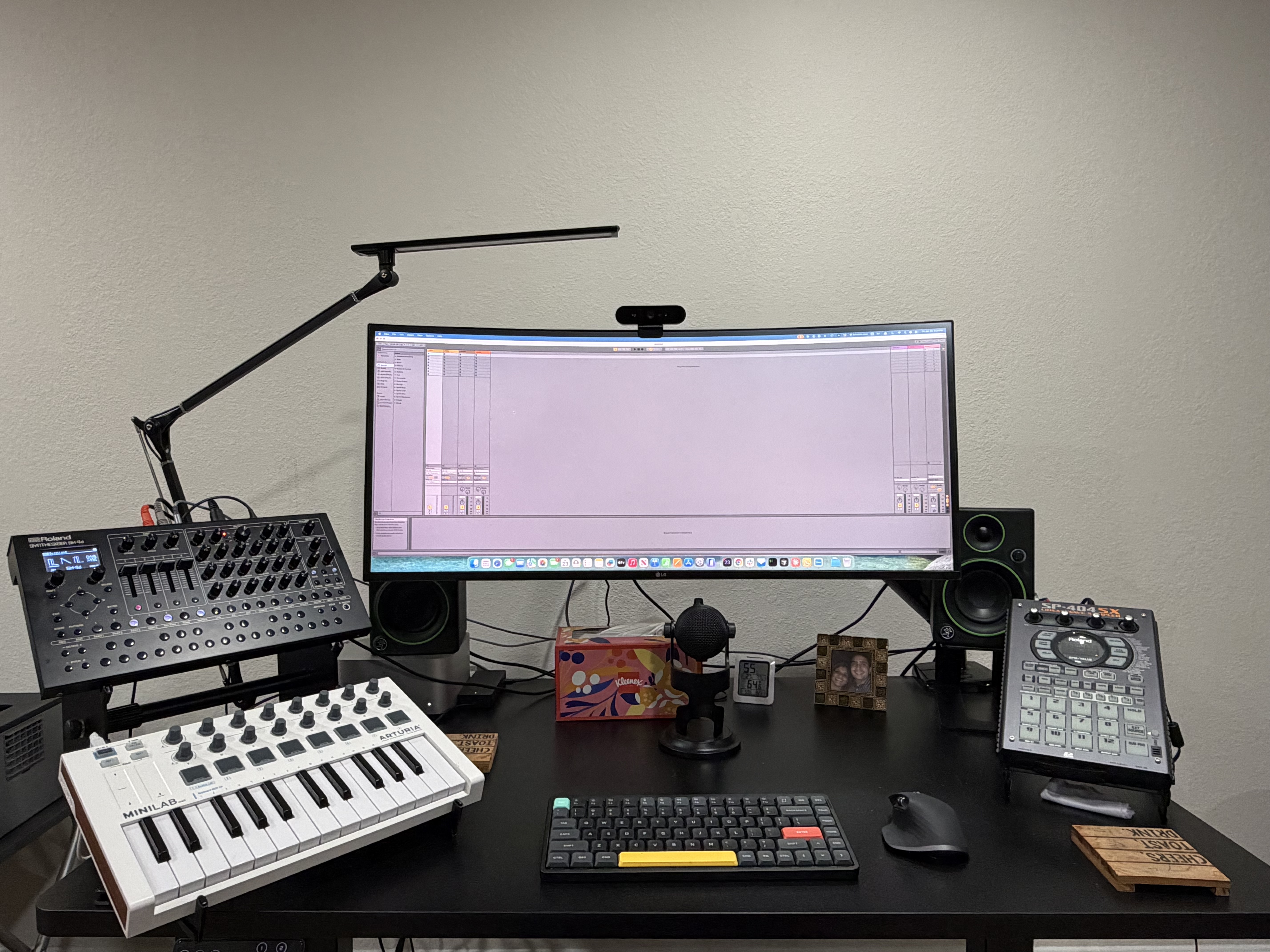 Home studio with synthesizer, MIDI keyboard, monitor, and sampler